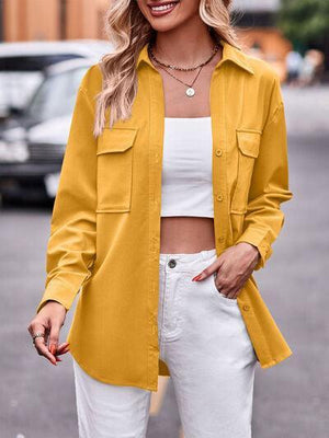 a woman wearing a yellow jacket and white pants