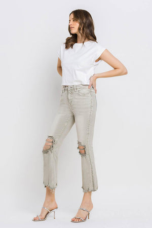 a woman in white shirt and jeans posing for a picture