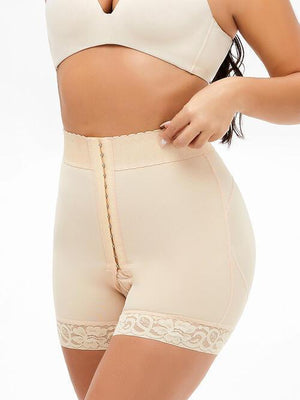 a woman in high waist shorts and a bra