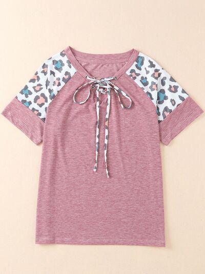 a t - shirt with a leopard print on the sleeves