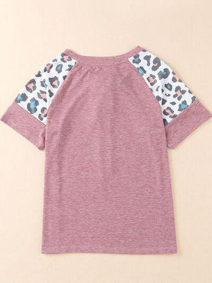 a pink shirt with leopard print sleeves