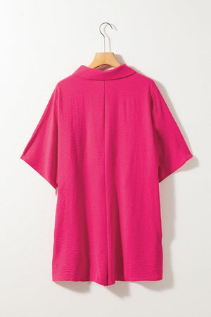 a pink shirt hanging on a white wall
