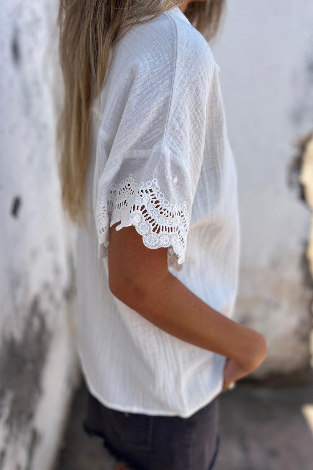 a woman wearing a white shirt and black pants