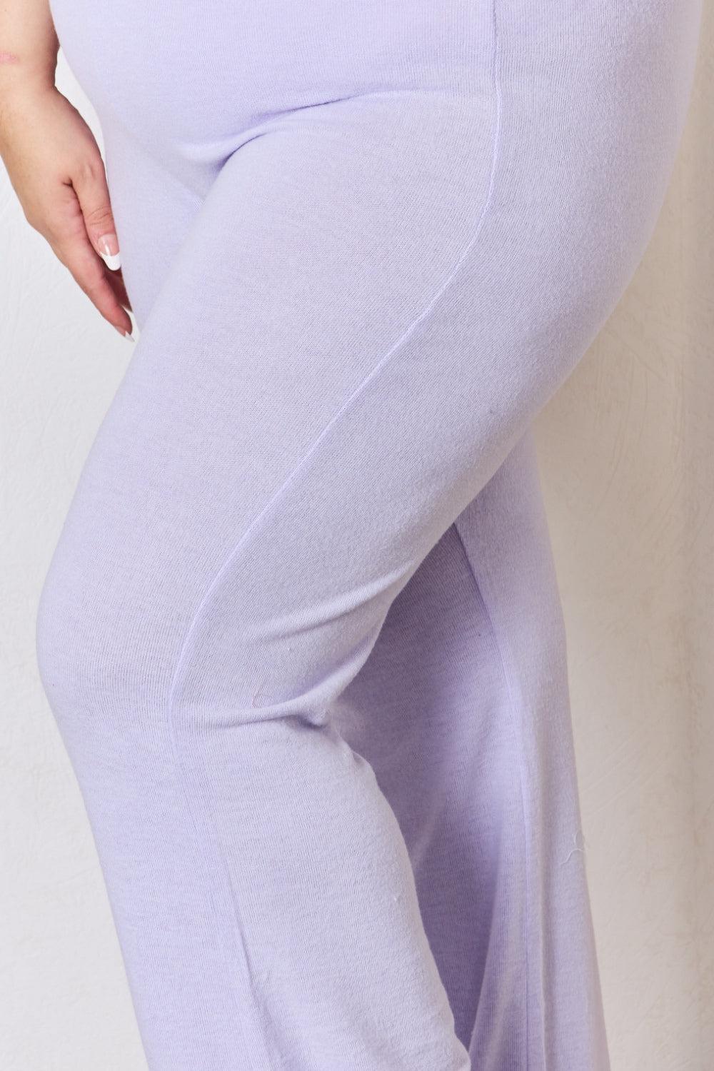 a woman in a purple top and pants