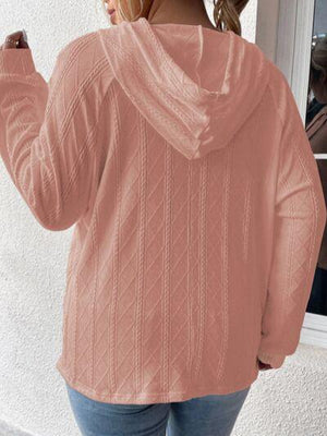 a woman wearing a pink sweater and jeans