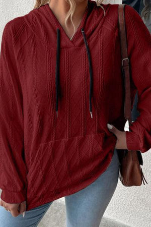 a woman wearing a red sweater and jeans