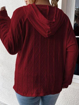 a woman wearing a red sweater and jeans