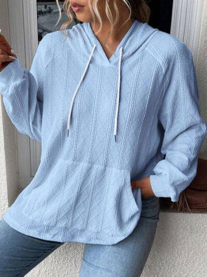 a woman wearing a blue sweater and jeans