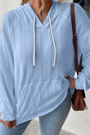 a woman wearing a blue sweater and jeans