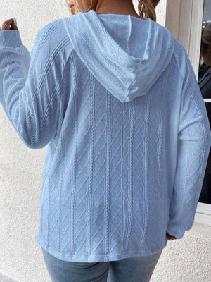 a woman wearing a blue sweater and jeans