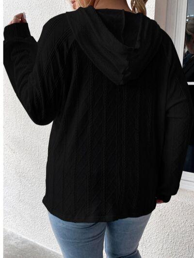 a woman wearing a black sweater and jeans