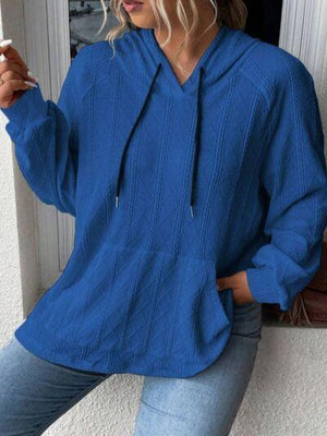 a woman wearing a blue sweater and jeans