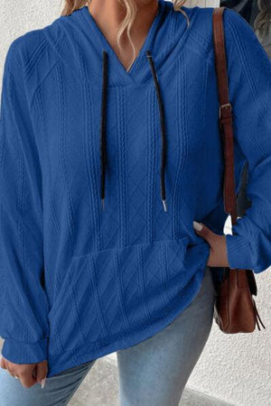 a woman wearing a blue sweater and jeans