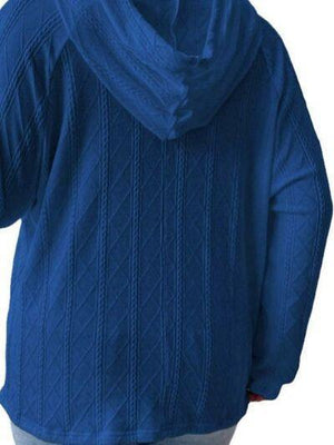 a woman wearing a blue sweater with a hoodie