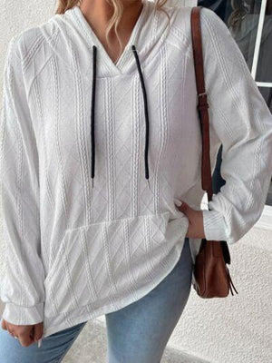 a woman wearing a white sweater and jeans