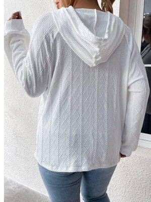 a woman wearing a white sweater and jeans