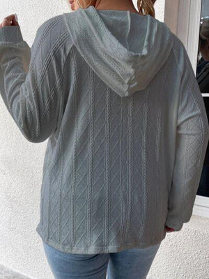 a woman wearing a gray sweater and jeans