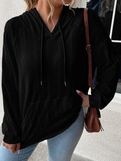 a woman wearing a black sweater and jeans