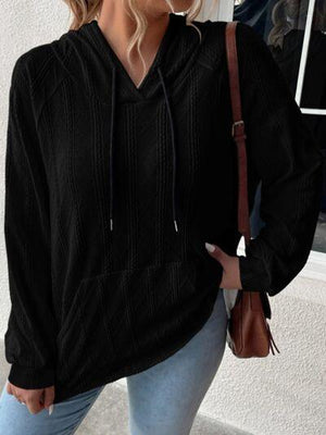 a woman wearing a black sweater and jeans