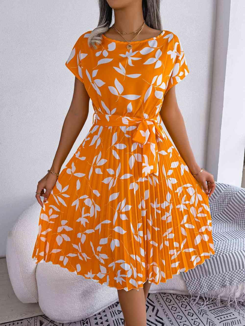 a woman wearing an orange and white dress
