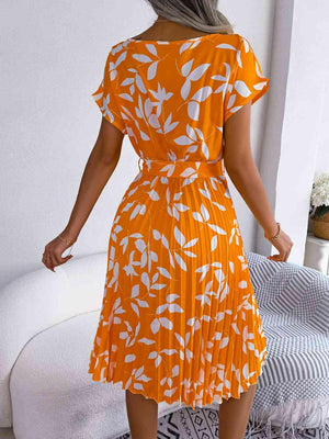 a woman in an orange and white dress