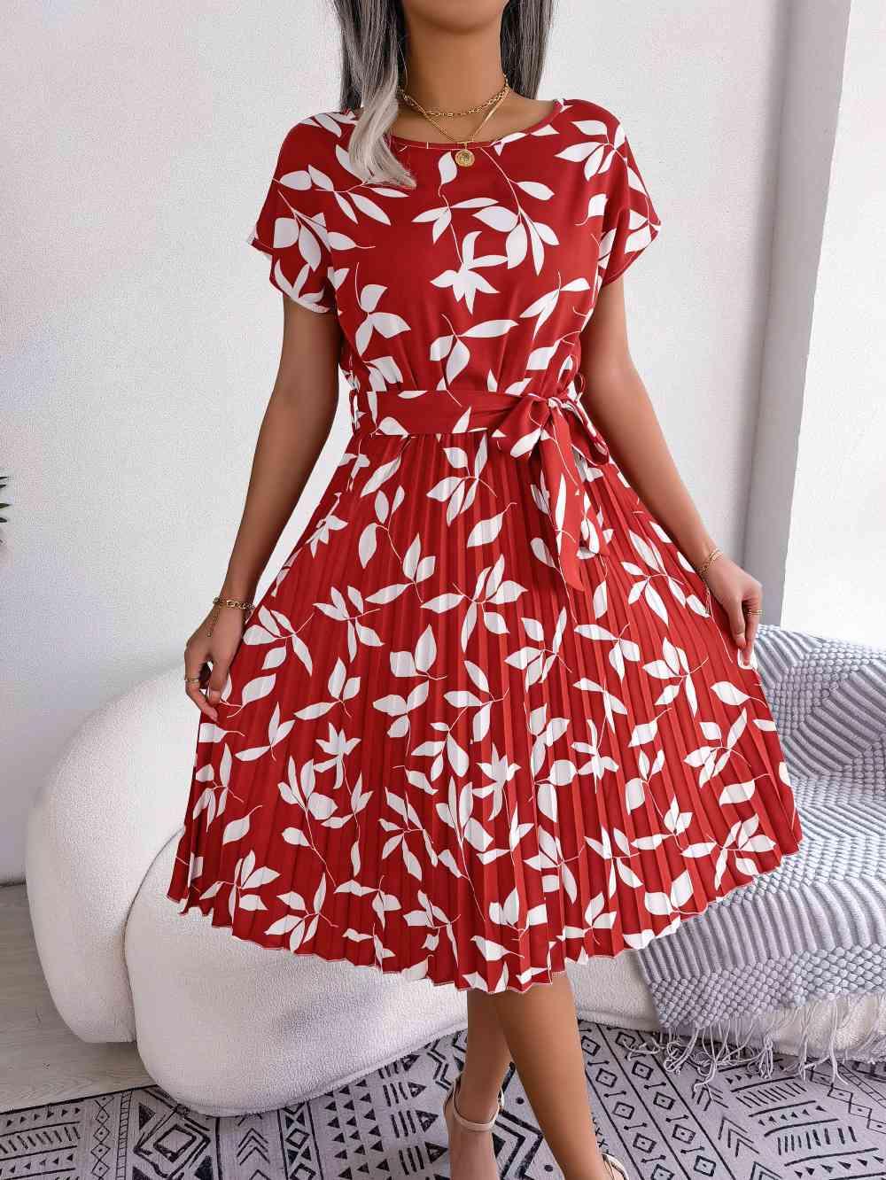 a woman wearing a red and white dress