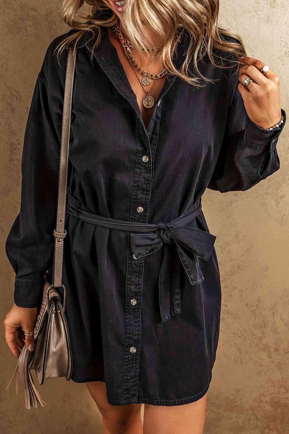 a woman wearing a black shirt dress