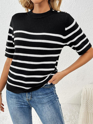 a woman wearing a black and white striped sweater