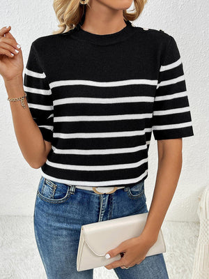 a woman wearing a black and white striped sweater
