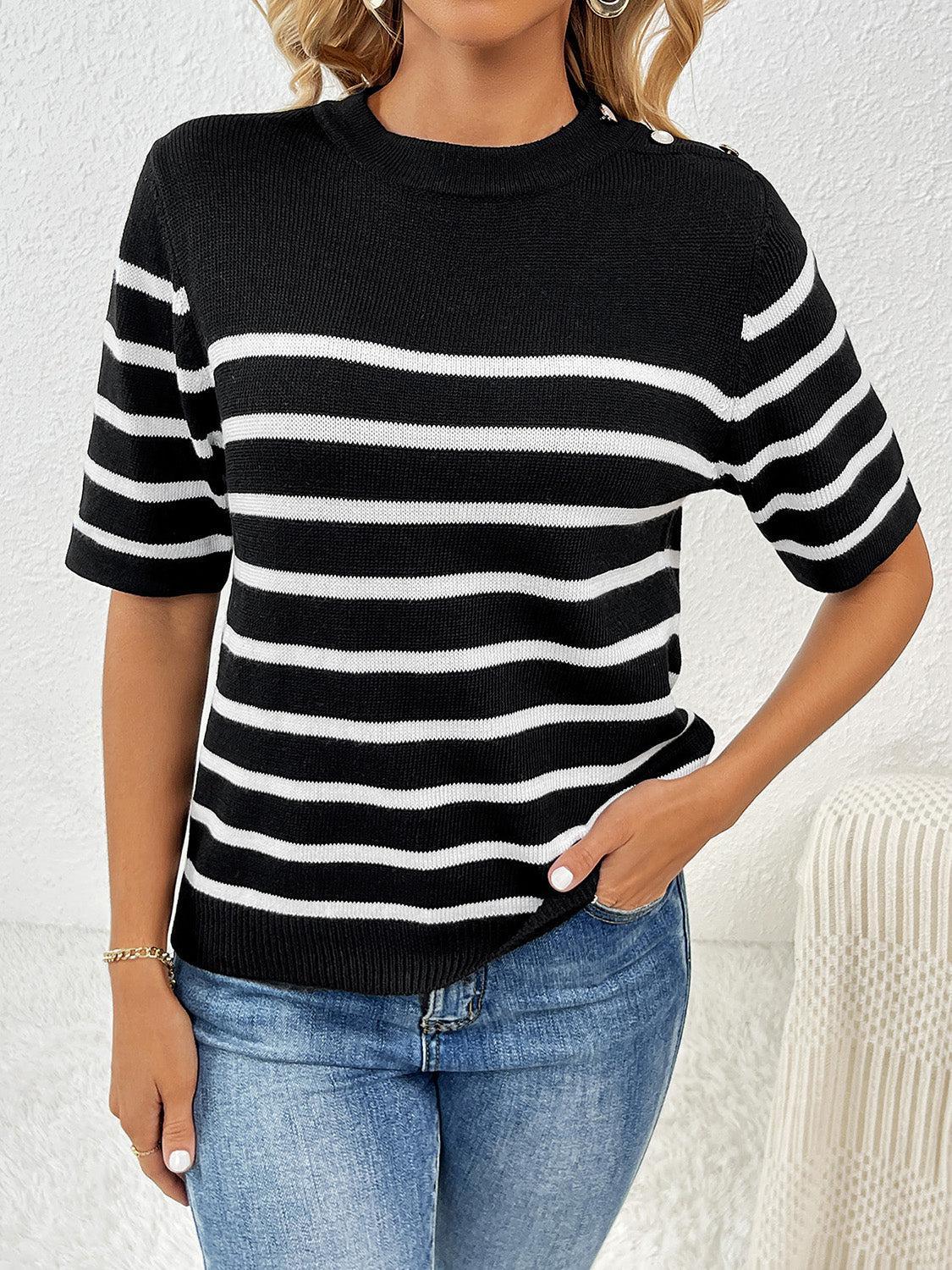 a woman wearing a black and white striped sweater