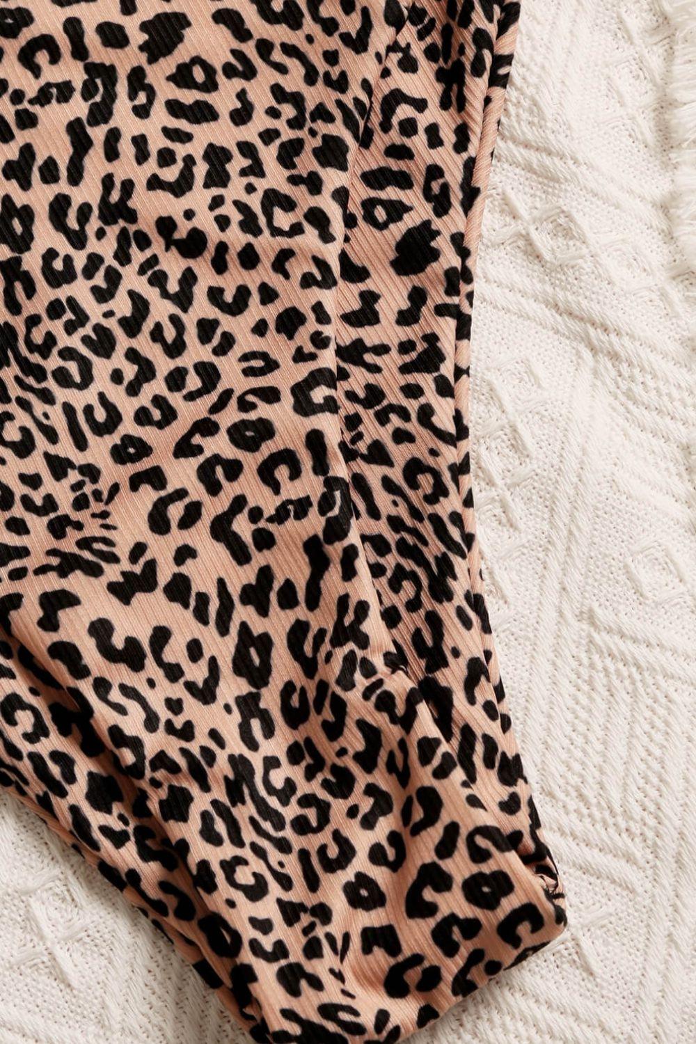 a leopard print skirt laying on top of a bed