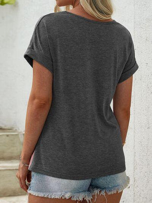 a woman wearing a grey shirt and denim shorts