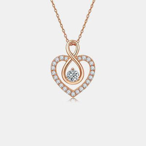 a heart shaped pendant with a diamond in the center