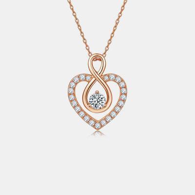 a heart shaped pendant with a diamond in the center