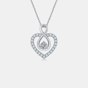 a heart shaped pendant with a diamond in the center