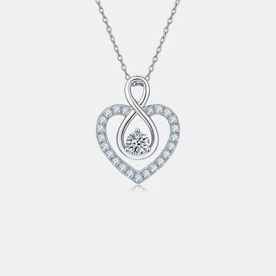 a heart shaped pendant with a diamond in the center