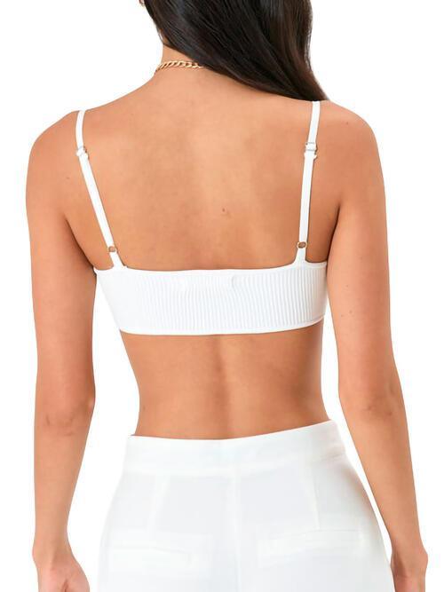 a woman wearing a white top and white pants