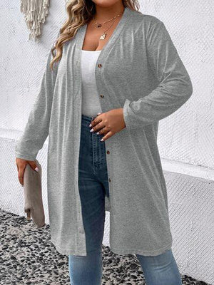a woman wearing a grey cardigan sweater and jeans