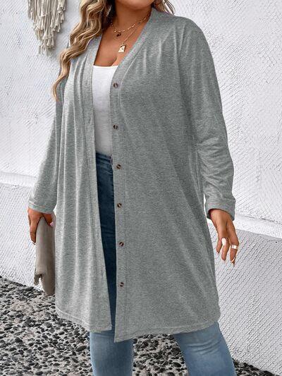 a woman wearing a grey cardigan sweater and jeans