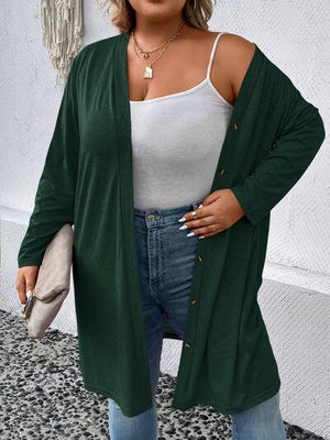 a woman wearing a green cardigan sweater and jeans