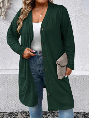 a woman wearing a green cardigan sweater and jeans