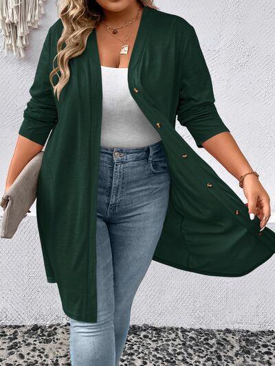 a woman wearing a green cardigan and jeans