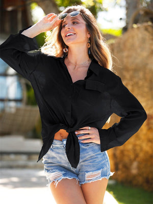 a woman wearing a black shirt and denim shorts