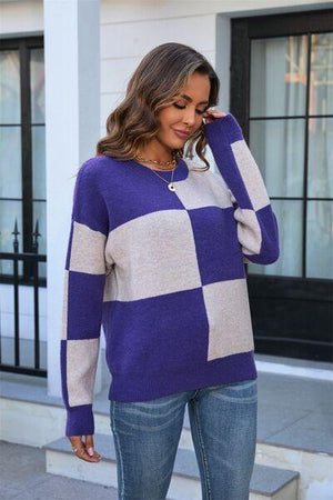 a woman wearing a purple and white checkered sweater