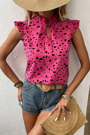 a woman wearing a straw hat and a pink top