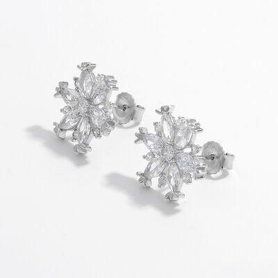 a pair of diamond earrings on a white background