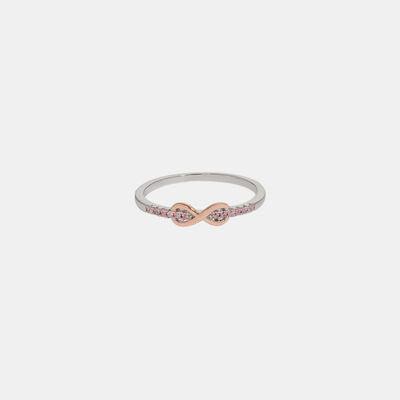a white and pink diamond ring on a white background