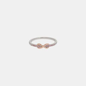 a white and pink diamond ring on a white background