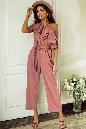 a woman in a pink jumpsuit posing for a picture