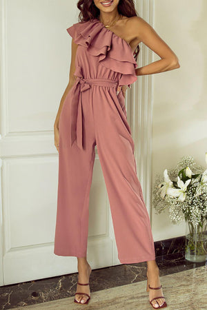 a woman in a pink jumpsuit posing for a picture
